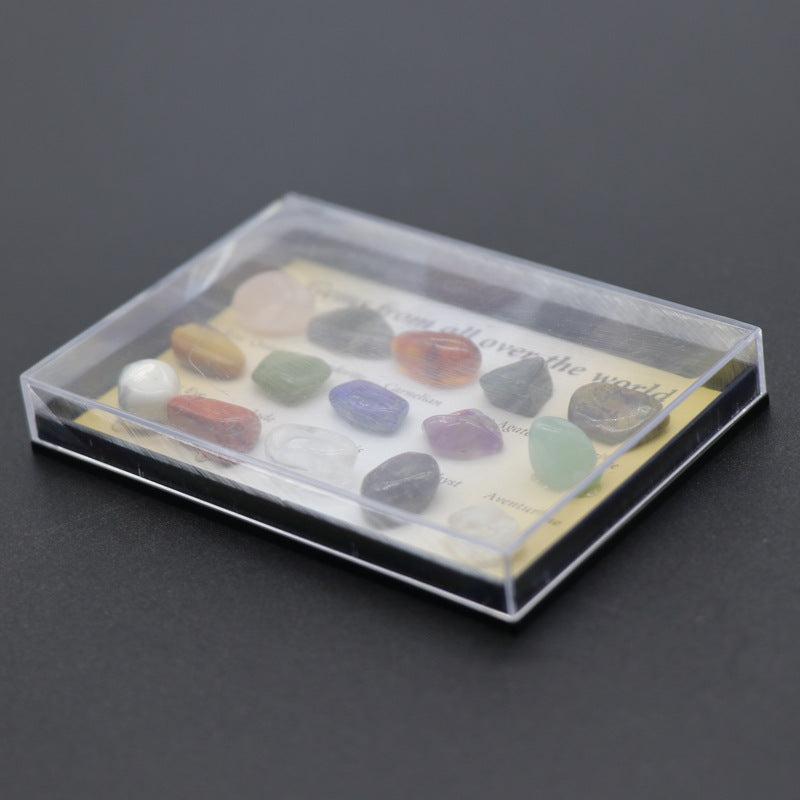 Set of colorful stones in a clear plastic case on a dark background