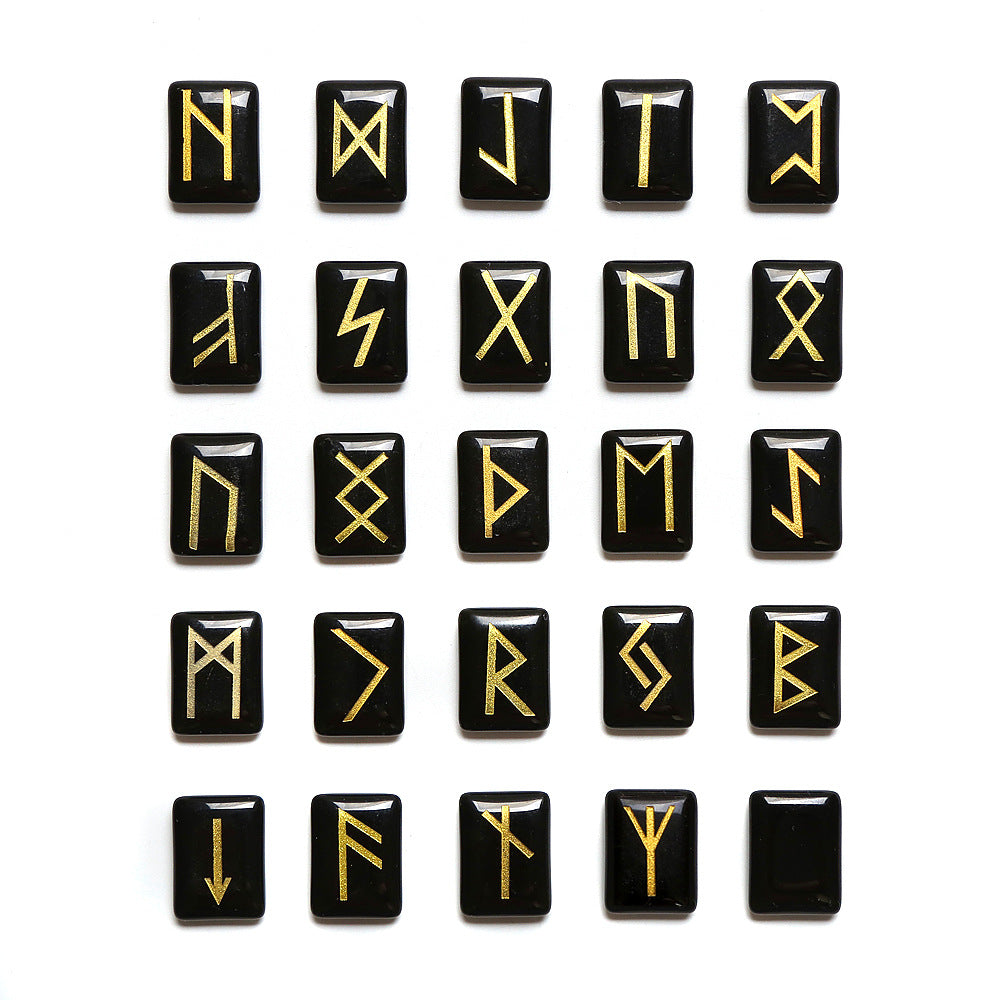 Set of black tiles with goldRunes arranged in a grid on a white background