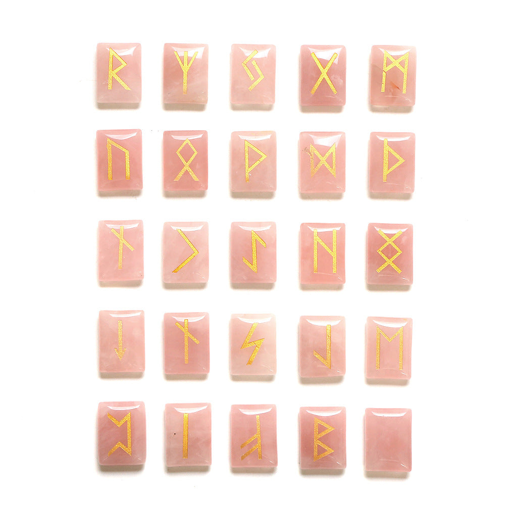 Set of pink rune stones with yellow symbols on a white background