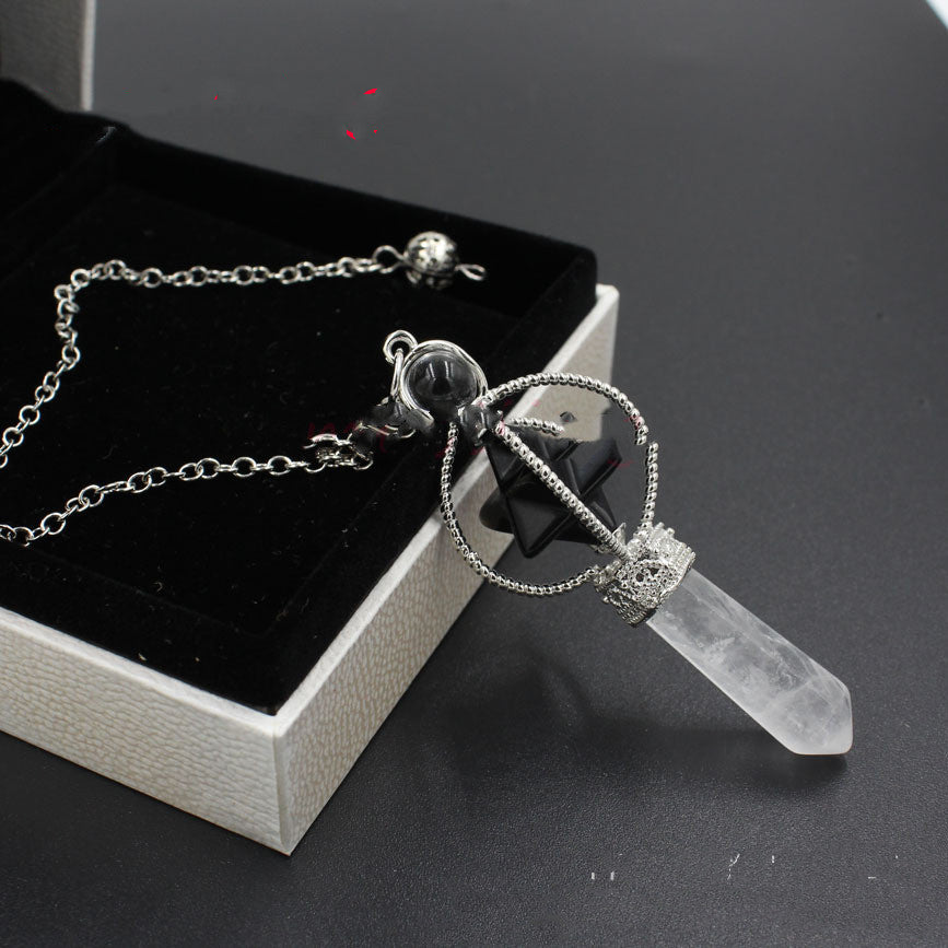Necklace with crystal pendant on a dark surface
