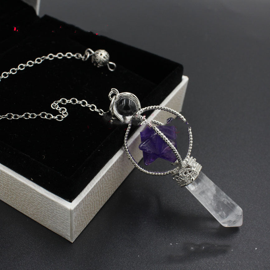 Necklace with crystal pendant on a dark surface