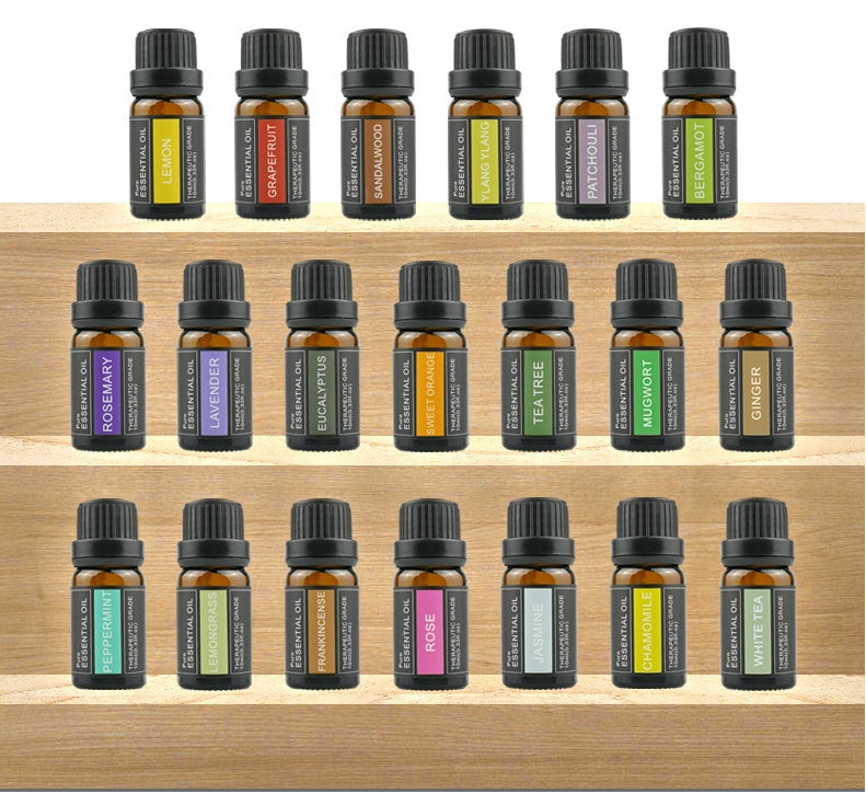 Collection of essential oil bottles on a wooden shelf