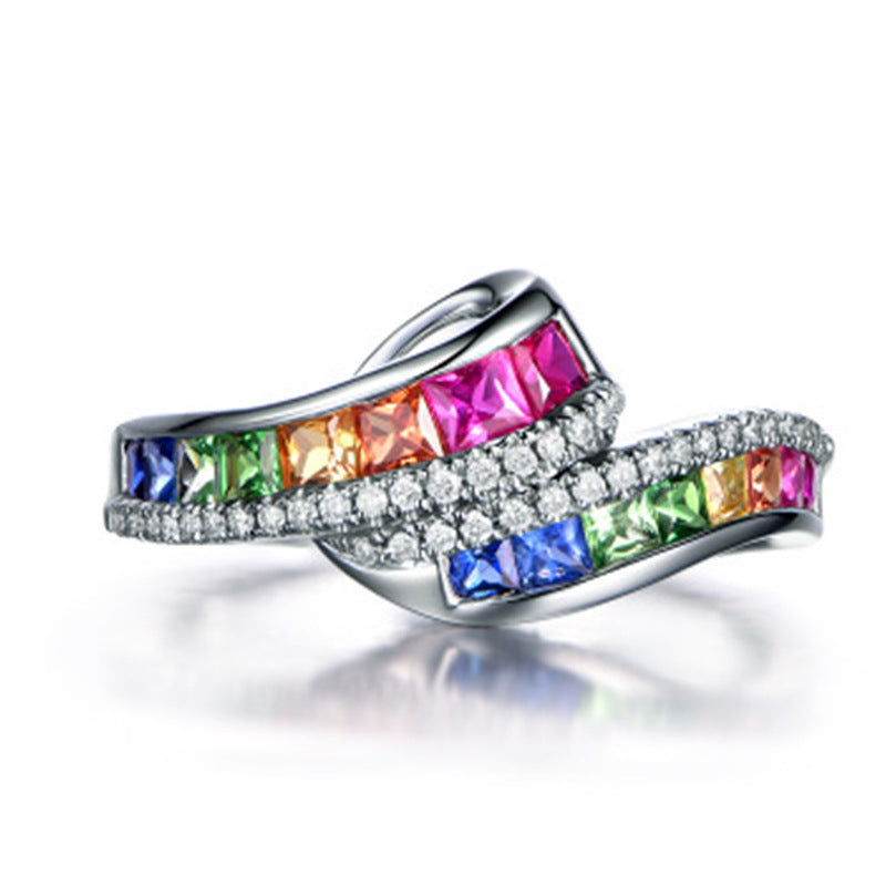 Silver ring with colorful gemstones on a white background