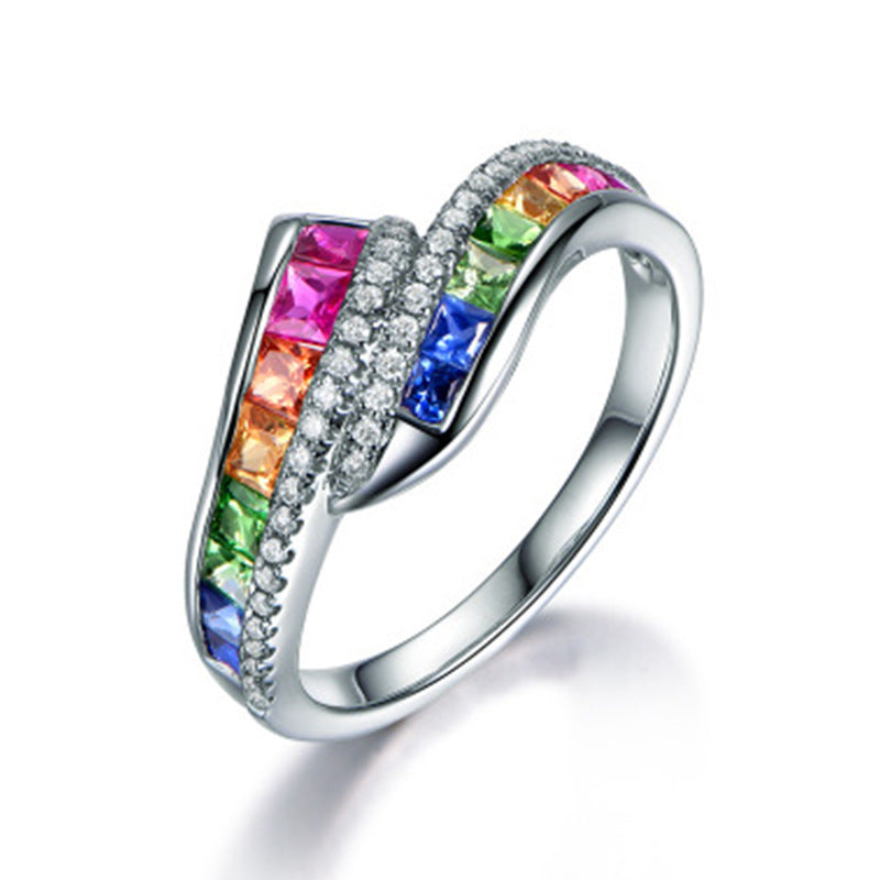 Silver ring with colorful gemstones on a white background