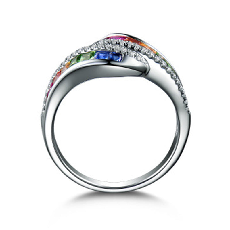 Silver ring with colorful gemstones on a white background