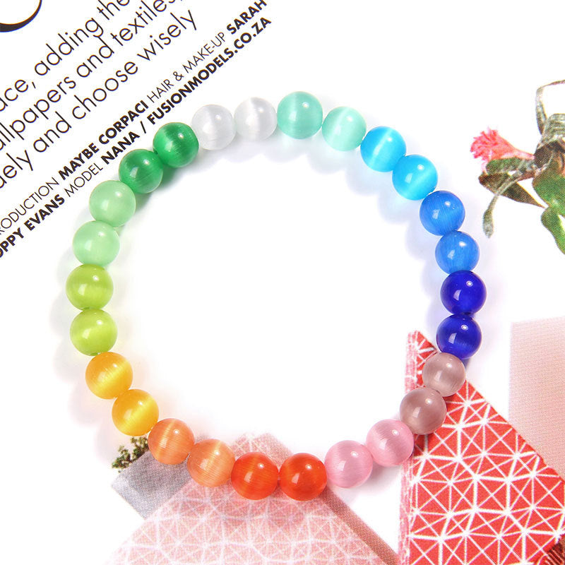 Colorful beaded bracelet on a magazine page with text and images.