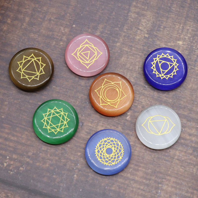 Set of colorful stones with symbols on a wooden surface