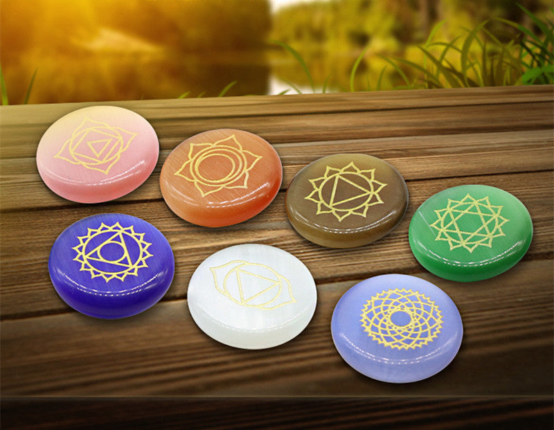 Set of colorful stones with symbols on a wooden surface