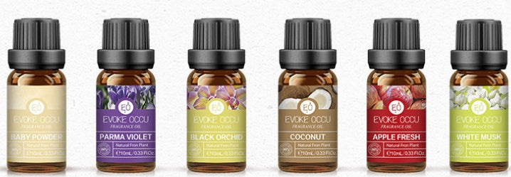 Row of essential oil bottles with labels on a white background