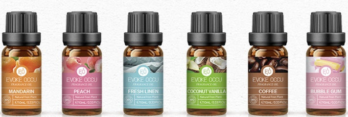 Row of essential oil bottles with visible labels on a white background