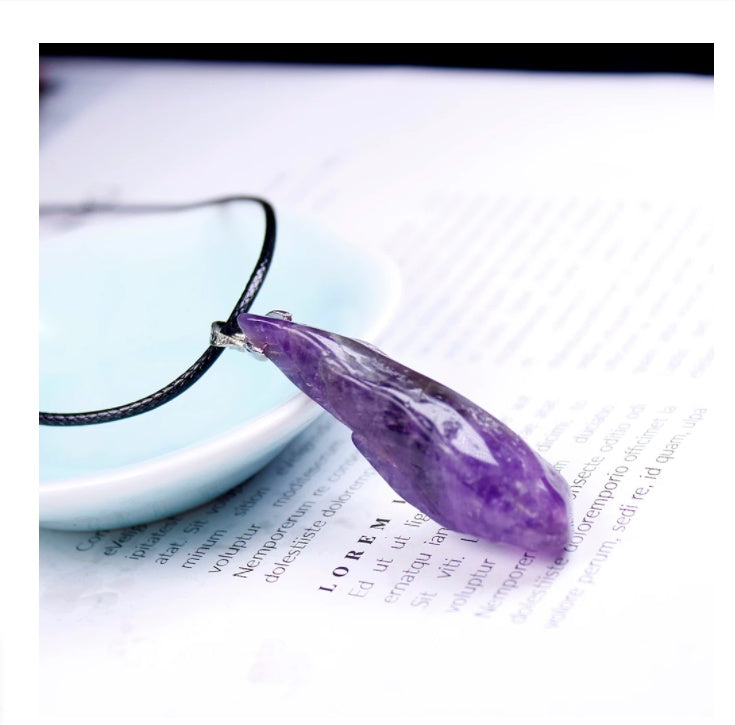 Purple teardrop-shaped pendant on a black cord against a white background