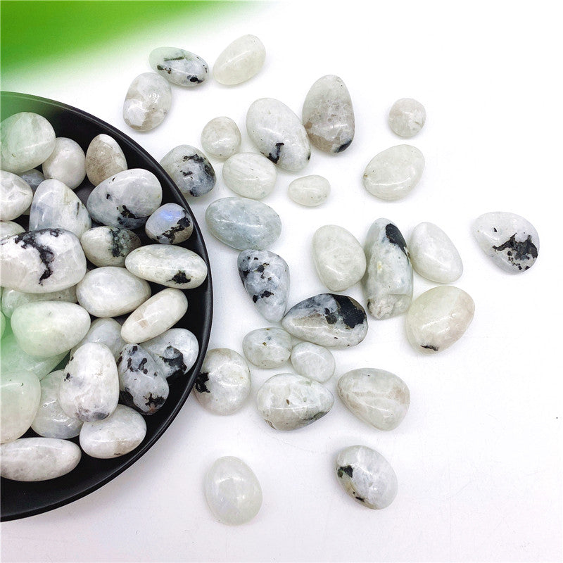 White stones with black spots on a white background