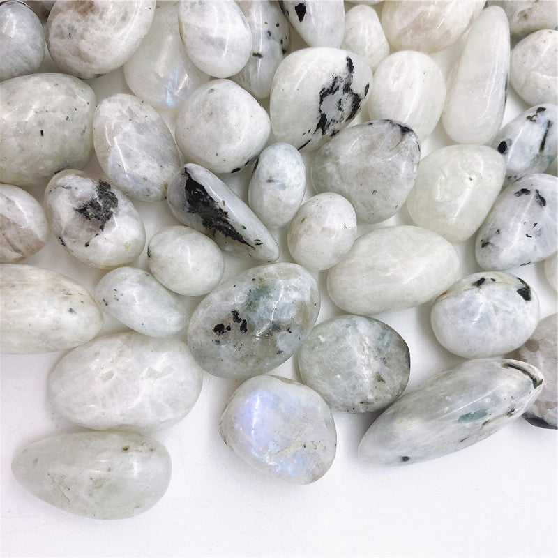 Close-up of white pebbles with black spots on a white background