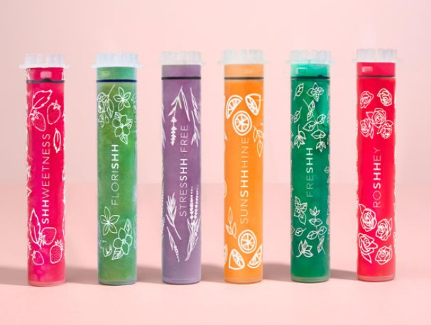 Colorful tubes with various designs and text on a pink background