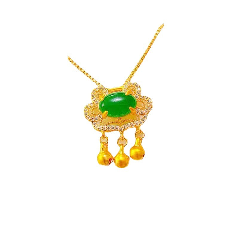Gold necklace with a green gemstone pendant on a white background