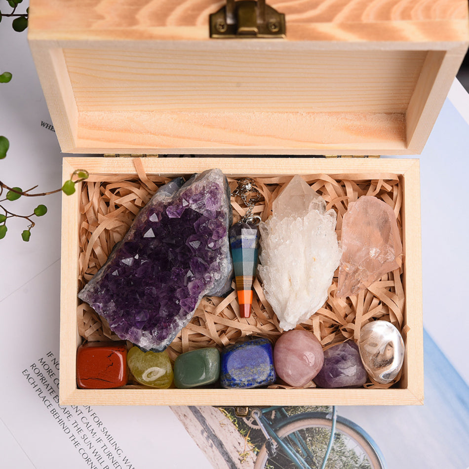 Wooden box with crystals and a rainbow necklace on a magazine background