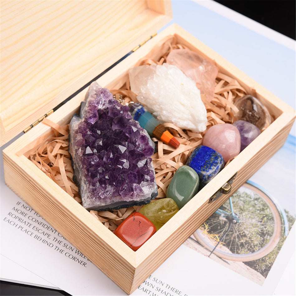 Box of colorful crystals including amethyst and rose quartz on an open book