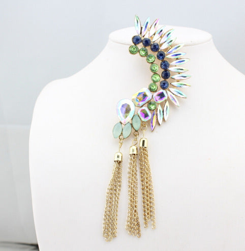 Elegant earring with gemstones and tassels on a mannequin bust.
