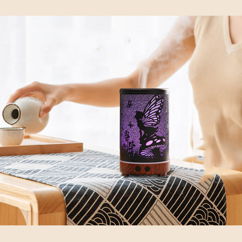 Person pouring tea into a cup with a purple fairy design on a table.