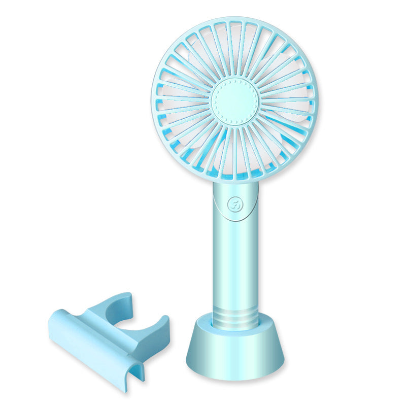Light blue handheld fan with stand on a white background