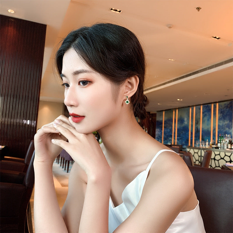 Woman wearing earrings in a restaurant setting