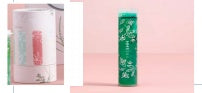 Green tea canister with a pink label on a light pink background