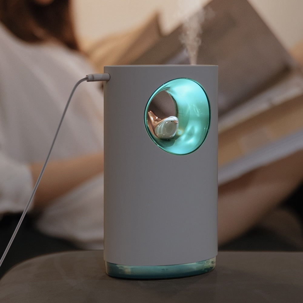 Gray and green humidifier on a table with a blurred background