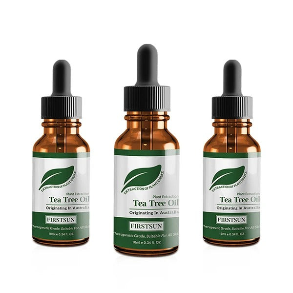 Three bottles of Tea Tree Oil with dropper caps on a white background