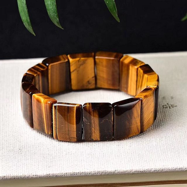 Tiger eye bracelet on a white surface with a dark background