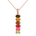 Multicolored gemstone necklace with rose gold chain on a white background