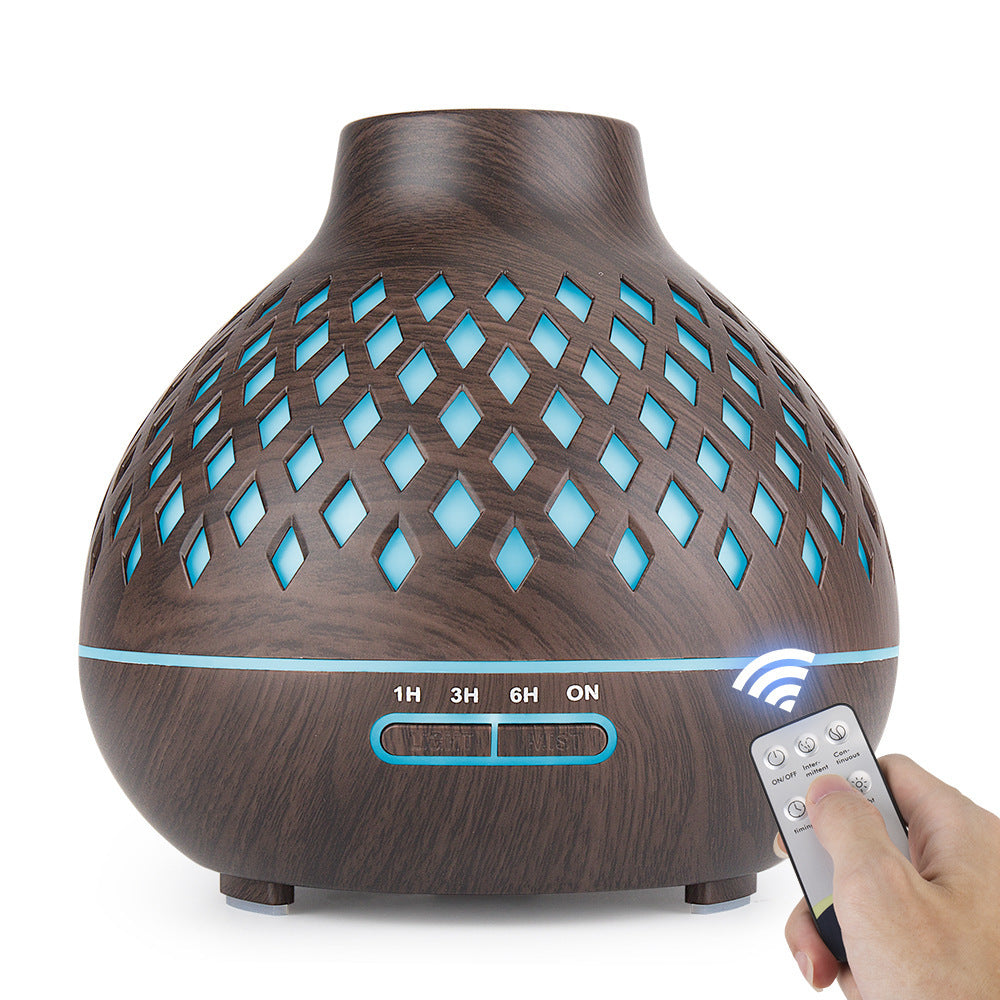 Wooden diffuser with blue lights and a remote control on a white background