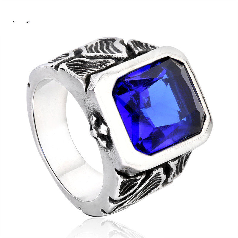 Silver ring with a blue gemstone on a white background