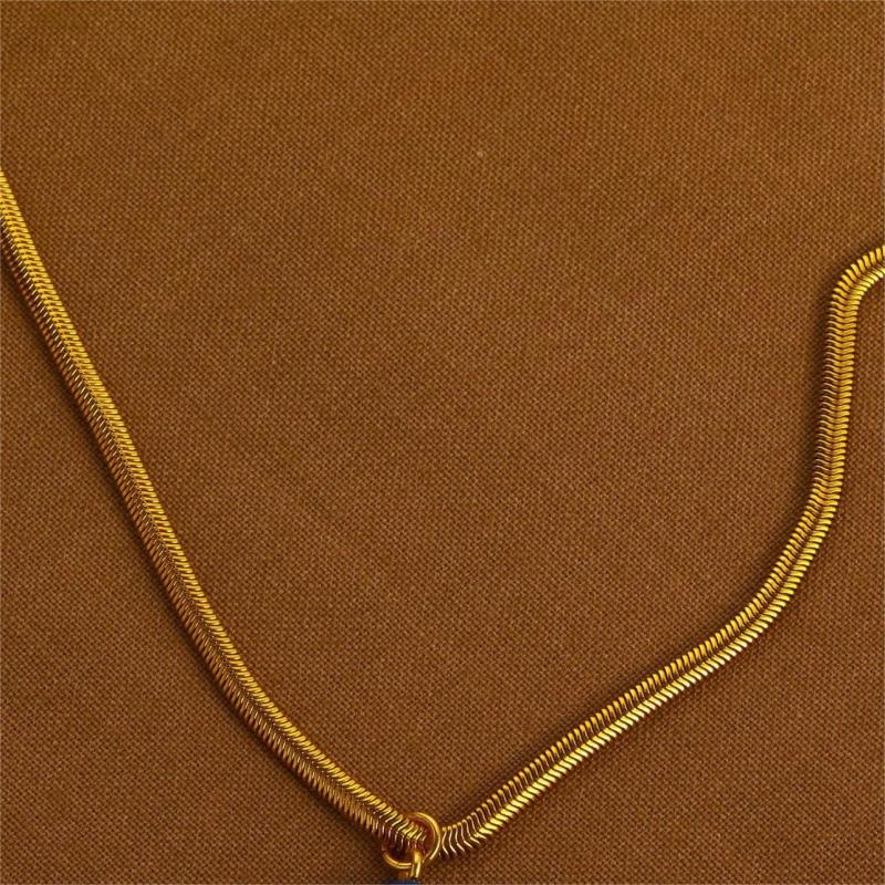 Gold chain on a brown fabric background