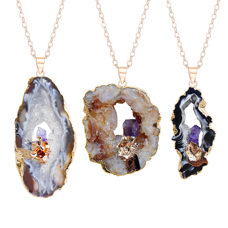 Three geode-style necklaces with embedded crystals on a white background