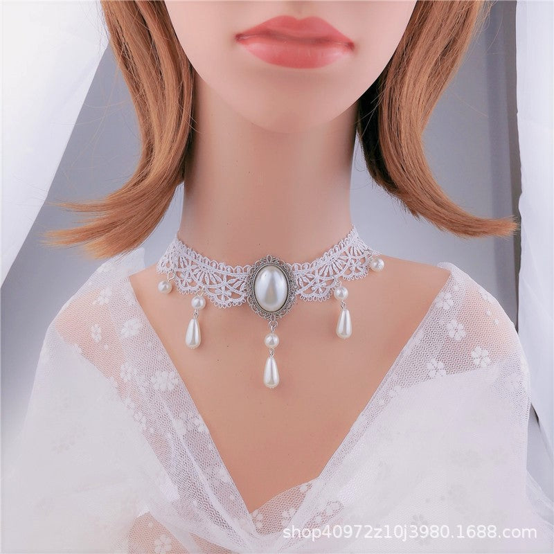 Mannequin wearing a delicate pearl necklace with a white lace top.