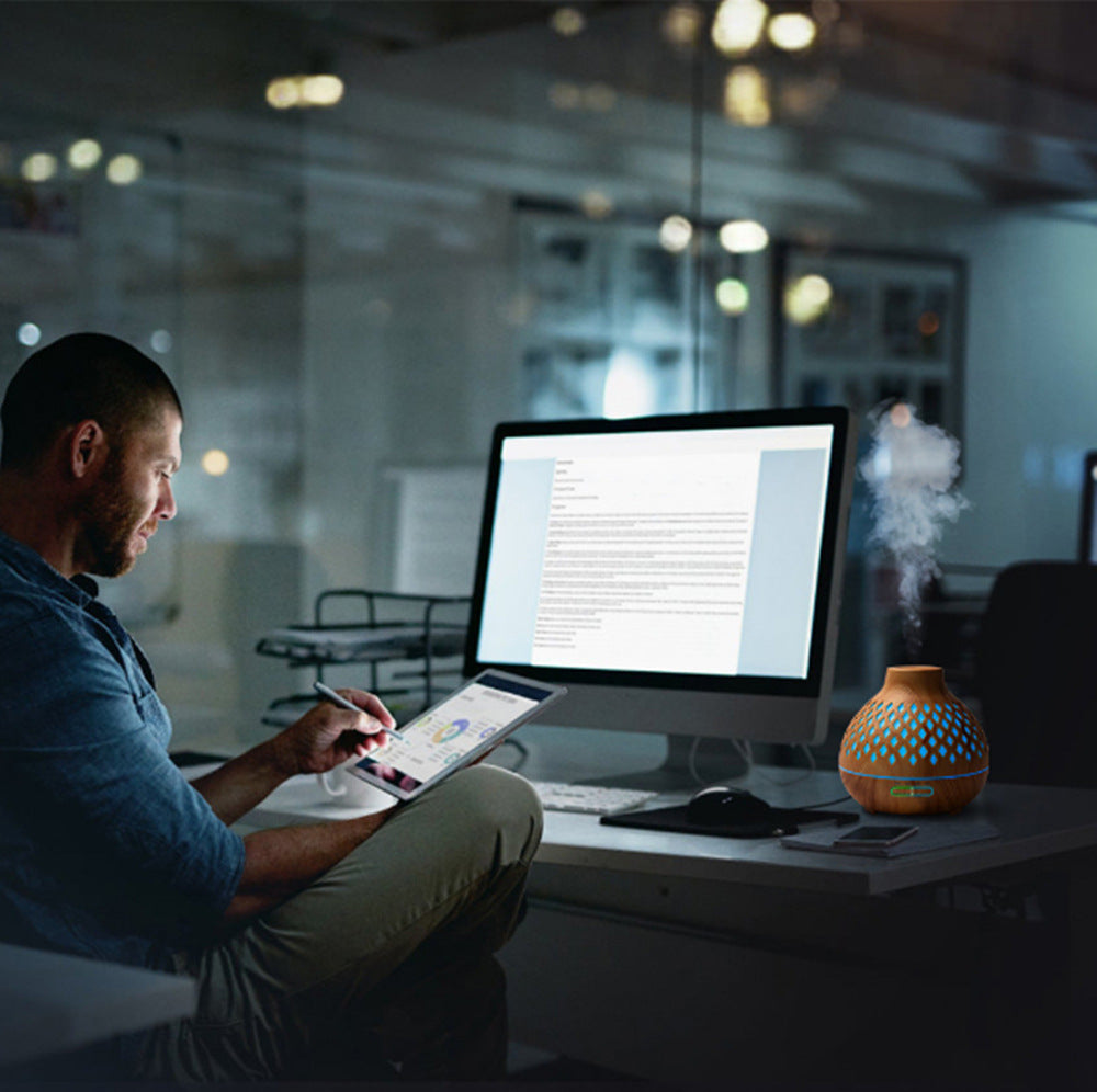 Person working on a laptop at a desk in an office setting