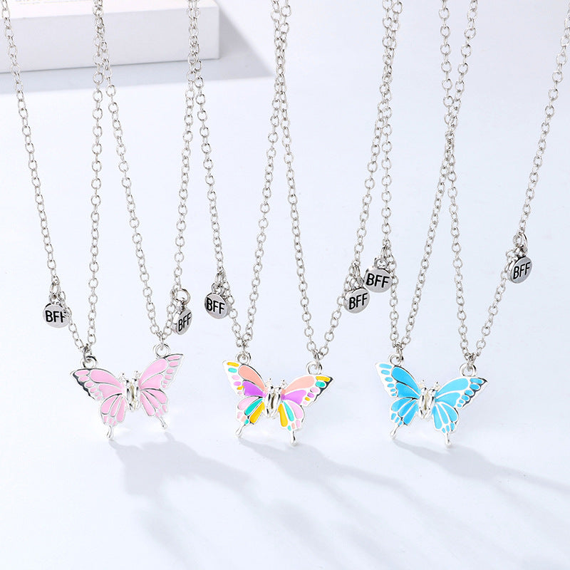 Butterfly necklaces with 'BFF' charms on a white background