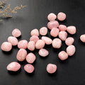 Pink stones on a black textured surface with decorative elements.