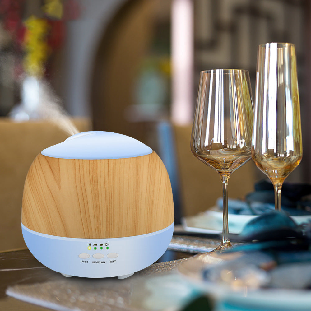 Wooden diffuser on a table with wine glasses in the background