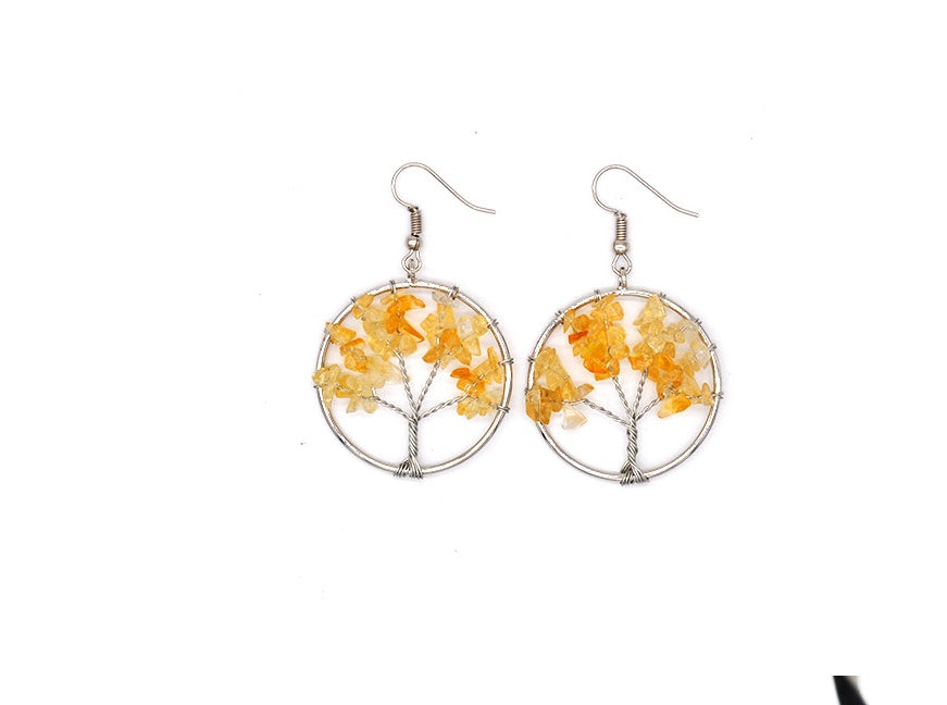 Round earrings with tree design and yellow elements on a white background