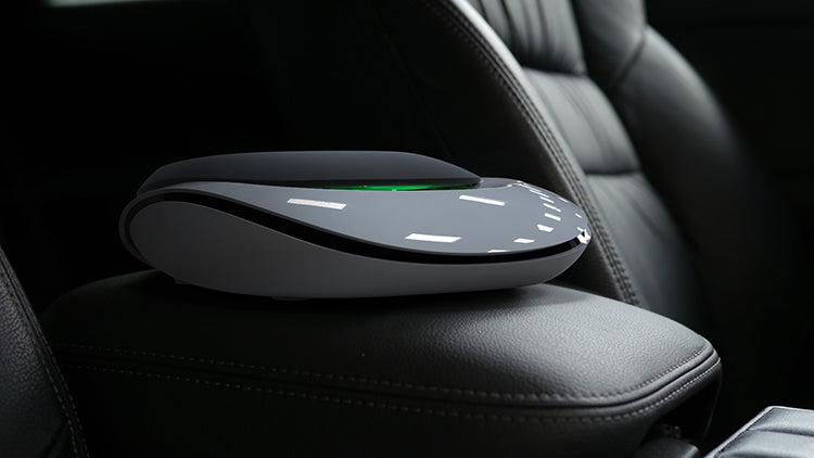 Car air freshener on a car seat with a dark background