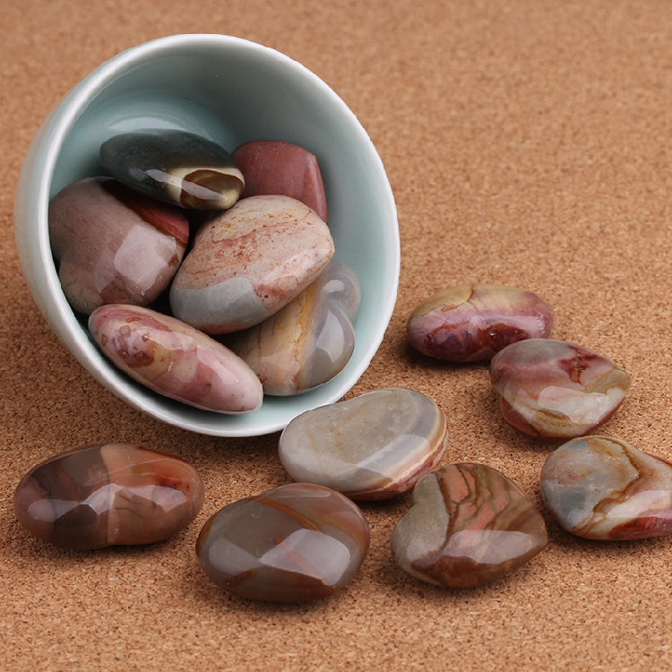White bowl filled with polished stones on a brown surface