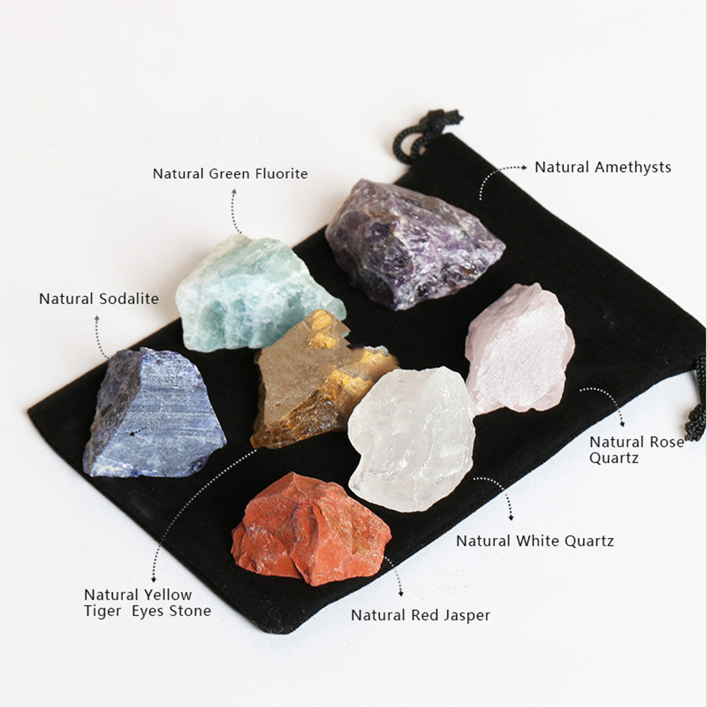 Set of various crystals on a black drawstring bag with labels.