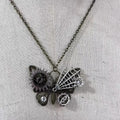 Steampunk-style butterfly necklace with gears and crystals on a light fabric background