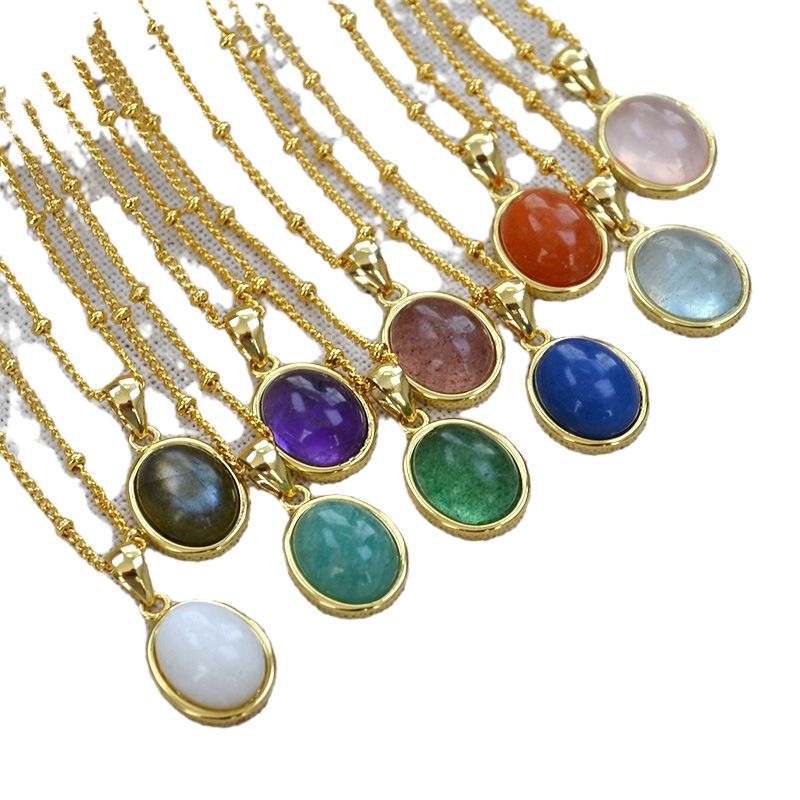 Set of gold necklaces with colorful gemstones on a white background