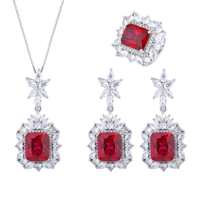 Jewelry set with red gemstones and silver accents on a white background