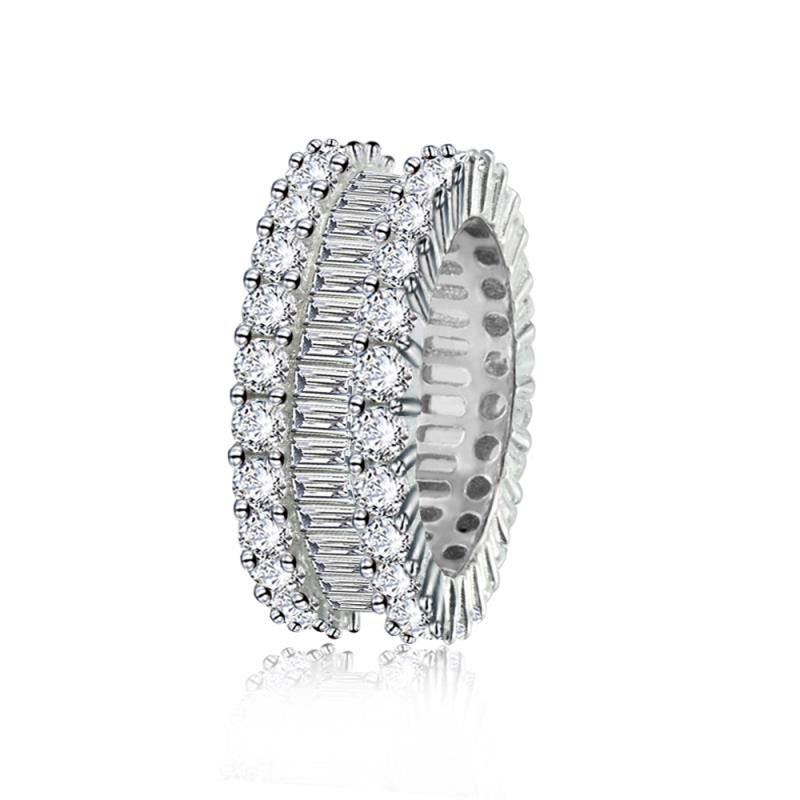Silver ring with clear gemstones on a white background