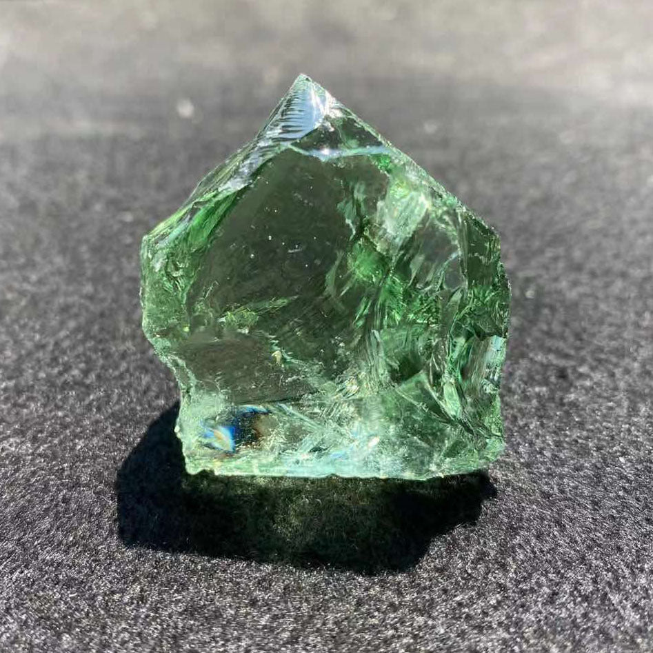 Green crystal on a dark surface