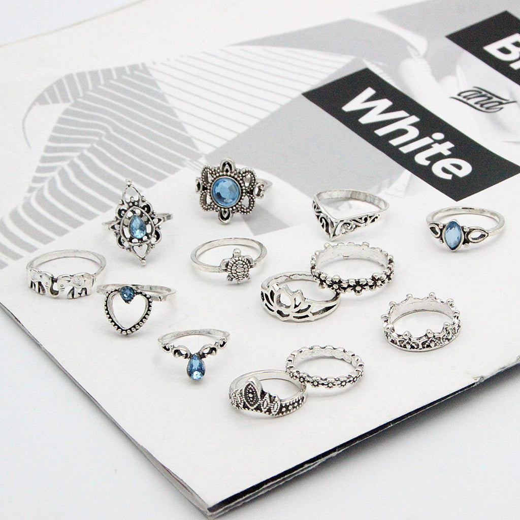 Set of silver rings with blue gemstones on a white box