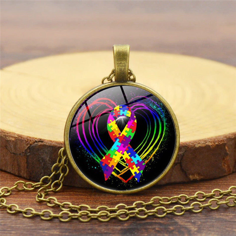 Necklace with a colorful ribbon and heart design on a wooden surface